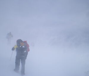 Expeditioners on survival training trekking through the blizzard conditioners