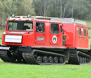 A red Hägglunds vehicle being used to train drivers