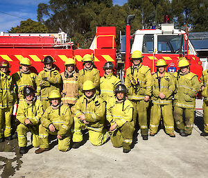 A photo of the Casey fire team in fire uniforms posing in front of a fire truck