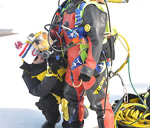 tender checking the divers gear