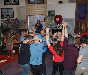 A group of expeditioners dancing to the music of the band