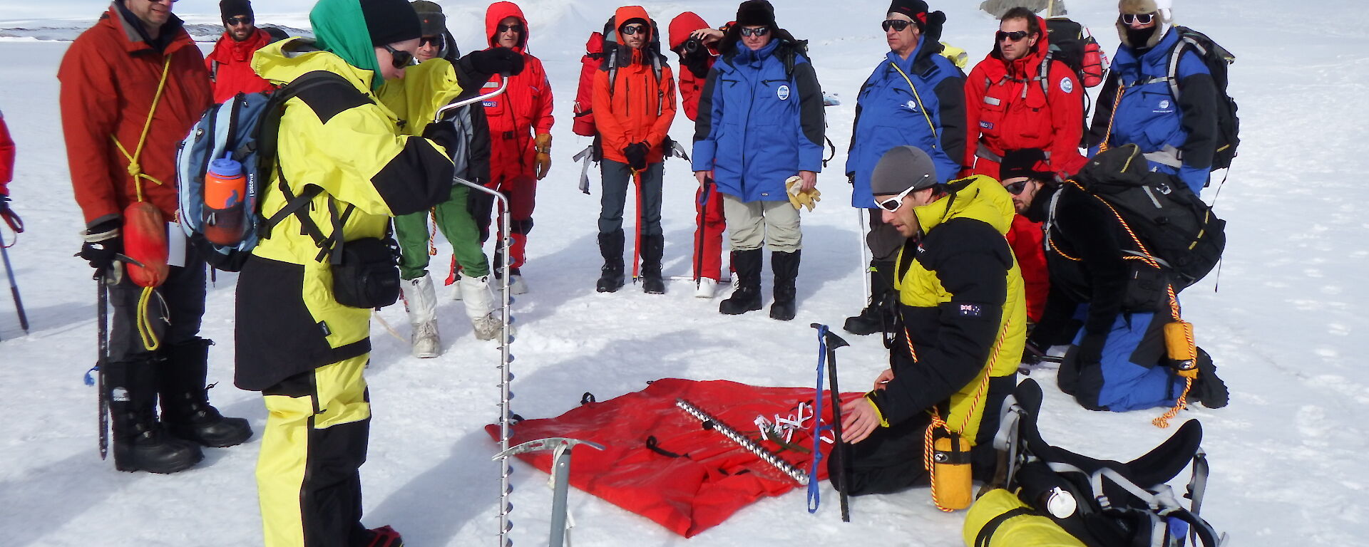 Foreign expeditioners being showed Antarctic survival equipment