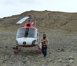 Expeditioner with helicopter at Hop Island