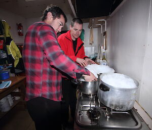 Expeditioners melt snow to top up the water supply