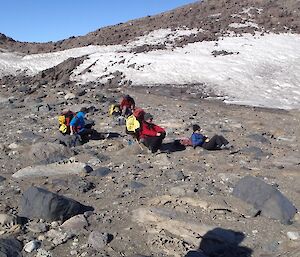 Group of expeditioners having a well earned rest on the rocks