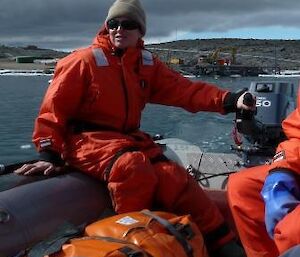 An expeditioner steering the boat.