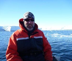 An expeditioner sits on the boat.