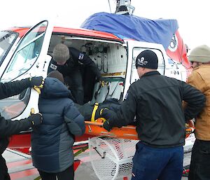 Expeditioners practise loading a patient into the helicopter.