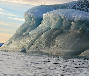 Adelie penguins on a jade coloured iceberg.