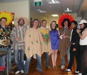 Group of expeditioners at Mexican theme party featuring people dressed in ponchos and sombreros