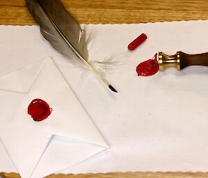 Paper, feather, envelope and wax stamp