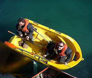 Ken and Ben in a yellow inflatable boat as viewed from the top of the wharf