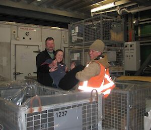 Expeditioners working at Davis — Goldie and Greg about to throw Jacki into a shipping crate