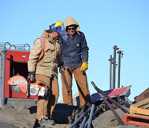 Brent Dennett and Ilias Zotos cut up the scaffold pipes