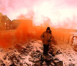 Mark Coade surrounded by orange smoke