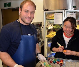 Davis expeditioners painting eggs