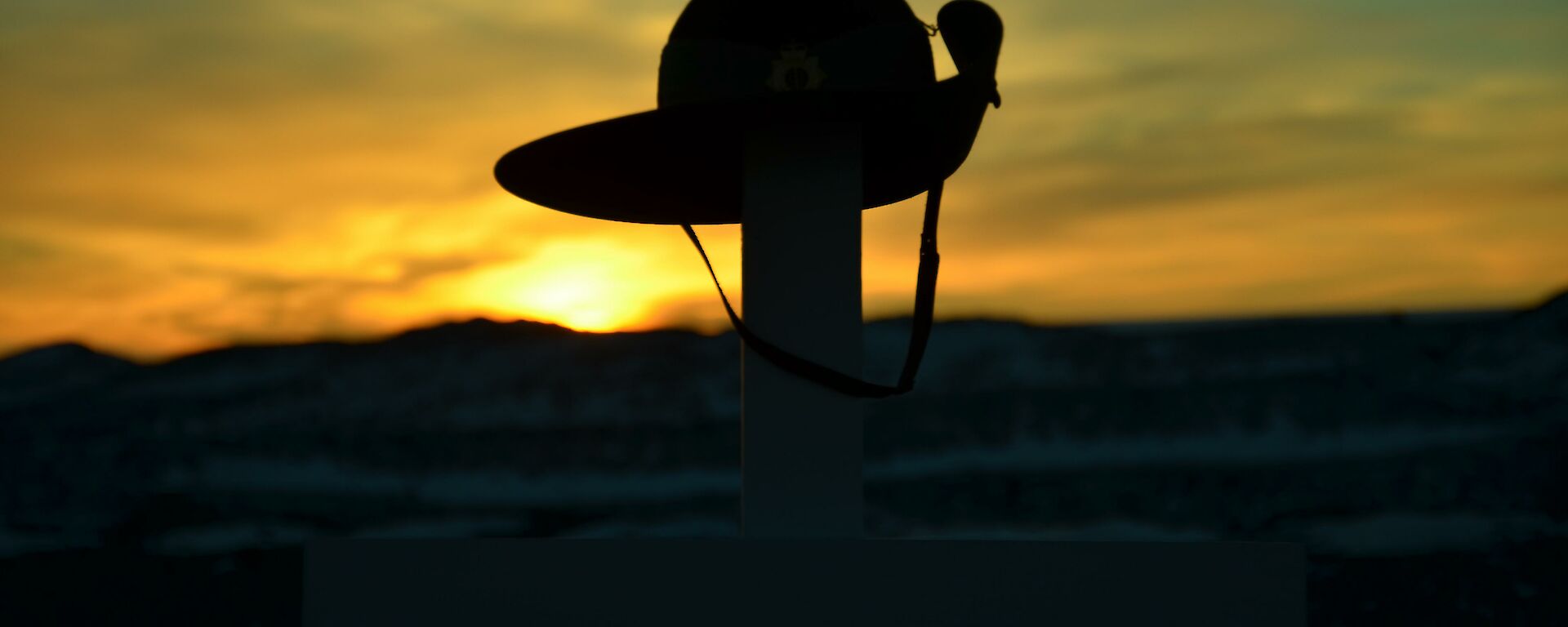 Sunrise at Davis Anzac Day 2012 — sunrise behind army hat