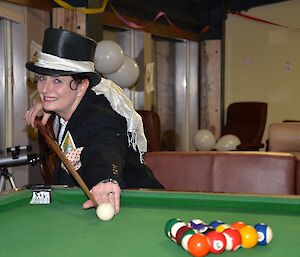Expeditioner playing pool while wearing a top hat
