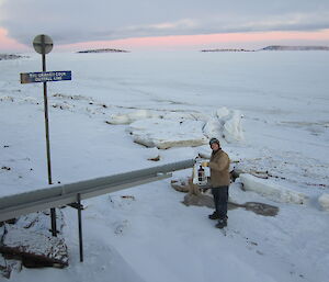 Plumber sampling sewage at Davis