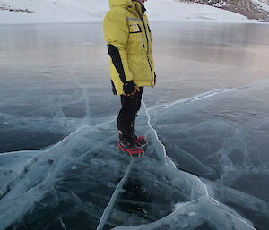 Expeditioner stands on Watts Lake which is frozen solid