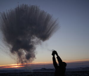 Hot water throwing at minus −30°C by Steph at Davis 2012 with grey sky in background