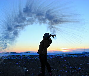 Steph MacDonald silhouette throwing hot water outside at Davis 2012