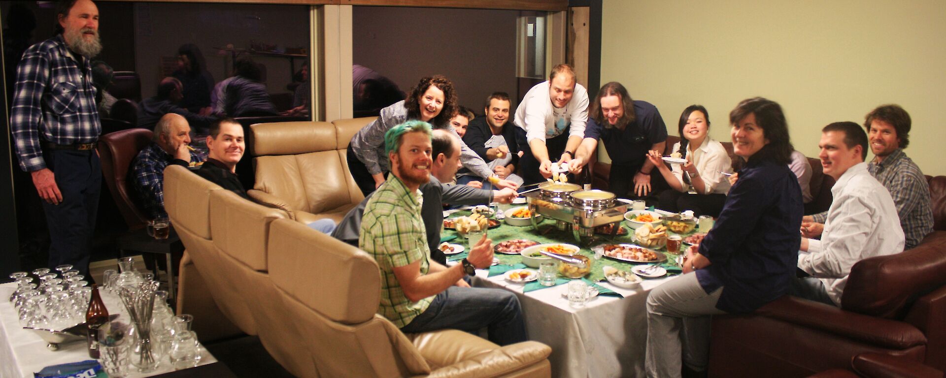 Fondue night at Davis 2012. Image shows a group of expeditioners seated around a table enjoying fondu