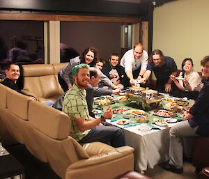 Fondue night at Davis 2012. Image shows a group of expeditioners seated around a table enjoying fondu