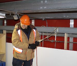 Tom Luttrell wearing a bright orange hardhat at SAR Training Davis 2012