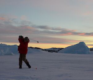 Davis Golf Game 2012 — golfer silhoutted with colourful sky laced with clouds in background