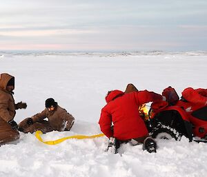 Davis Golf Game 2012. Expeditioners freeing a quad from ice and snow