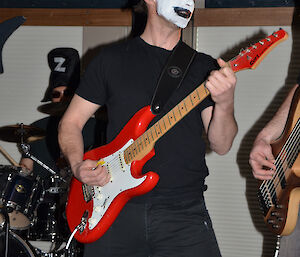 Joe Glacken at Davis 2012 with guitar and face painted like a member of KISS