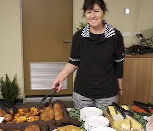 Midwinter brunch. Brigid at the buffet selecting a danish