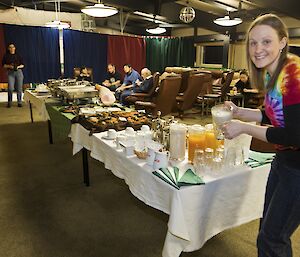 Steph MacDonald at Davis 2012 serving herself a drink from the buffet table