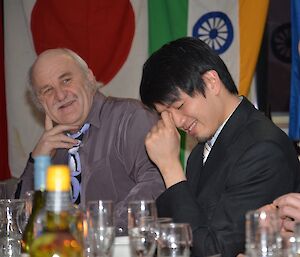 Steve Edwards and Nick Chang at Davis midwinter dinner 2012 smiling during the reading of the excuses