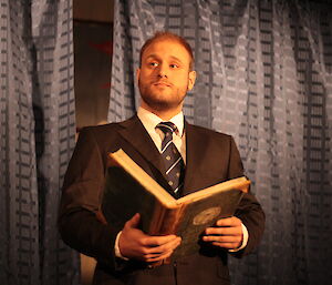 Man reading from a book during the midwinter play