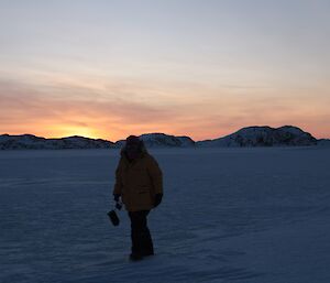 The rising sun barely peaks above the hills