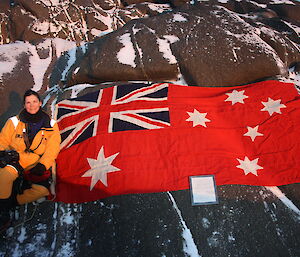 Cathie with the Australian Red Ensign at Wilkins Cairn July 2012