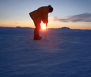 Coade drilling the sea ice at Davis 2012