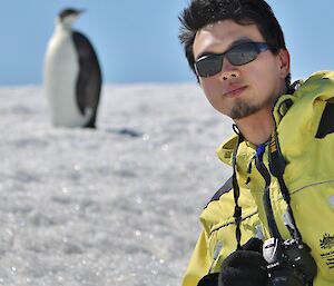 Nick Chang and an emperor penguin at Law Cairn