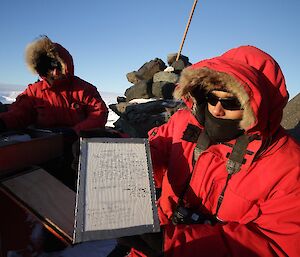 Expeditioner at Wilkins Cairn with Wilkins declaration 2012
