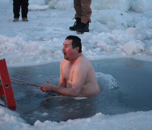 Expeditioner comes out of water during the mid winter swim