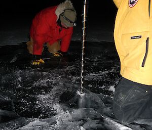Expeditioner looks into ice trying to see what’s below