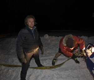 Linc Mainsbridge and Mark Baker get a ute ready to tow out of deep snow