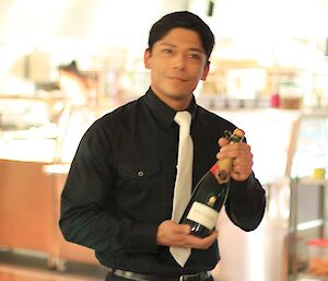 Jose holding a bottle of wine