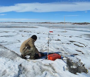 Adam Christensen checking stress gauges on the sea ice