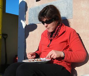Brigid Dwyer eating lunch outside Platcha hut at Davis 2012