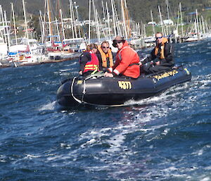 Four expeditioners in boat