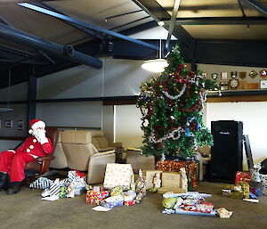 Santa surrounded by presents for distribution to the expeditioners