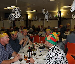 Expeditioners seated at tables waiting for the Christmas feast to begin